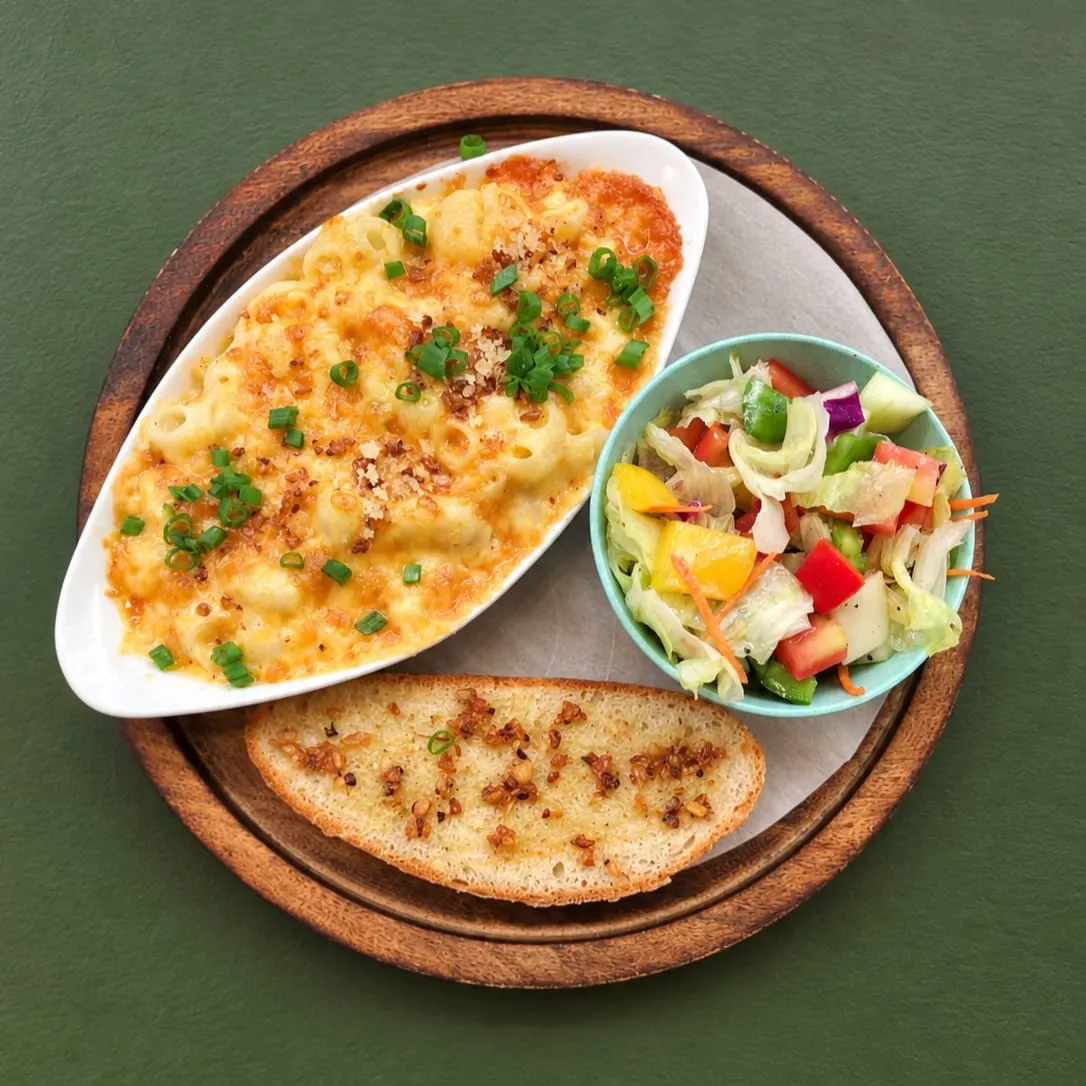 Freshly baked mac and cheese and  artisanal bread with melted cheese